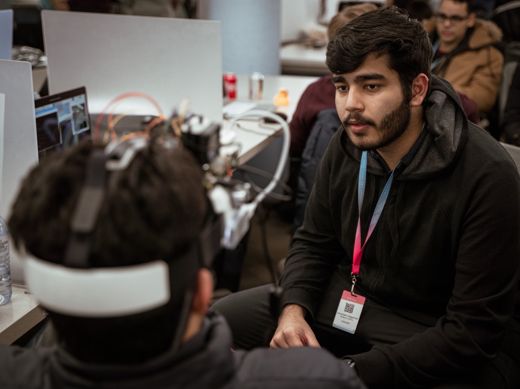 Himanshu Aggarwal interacting with Hamayoon Ashraf and testing VisionX before DeltaHacks 6 judging at McMaster University