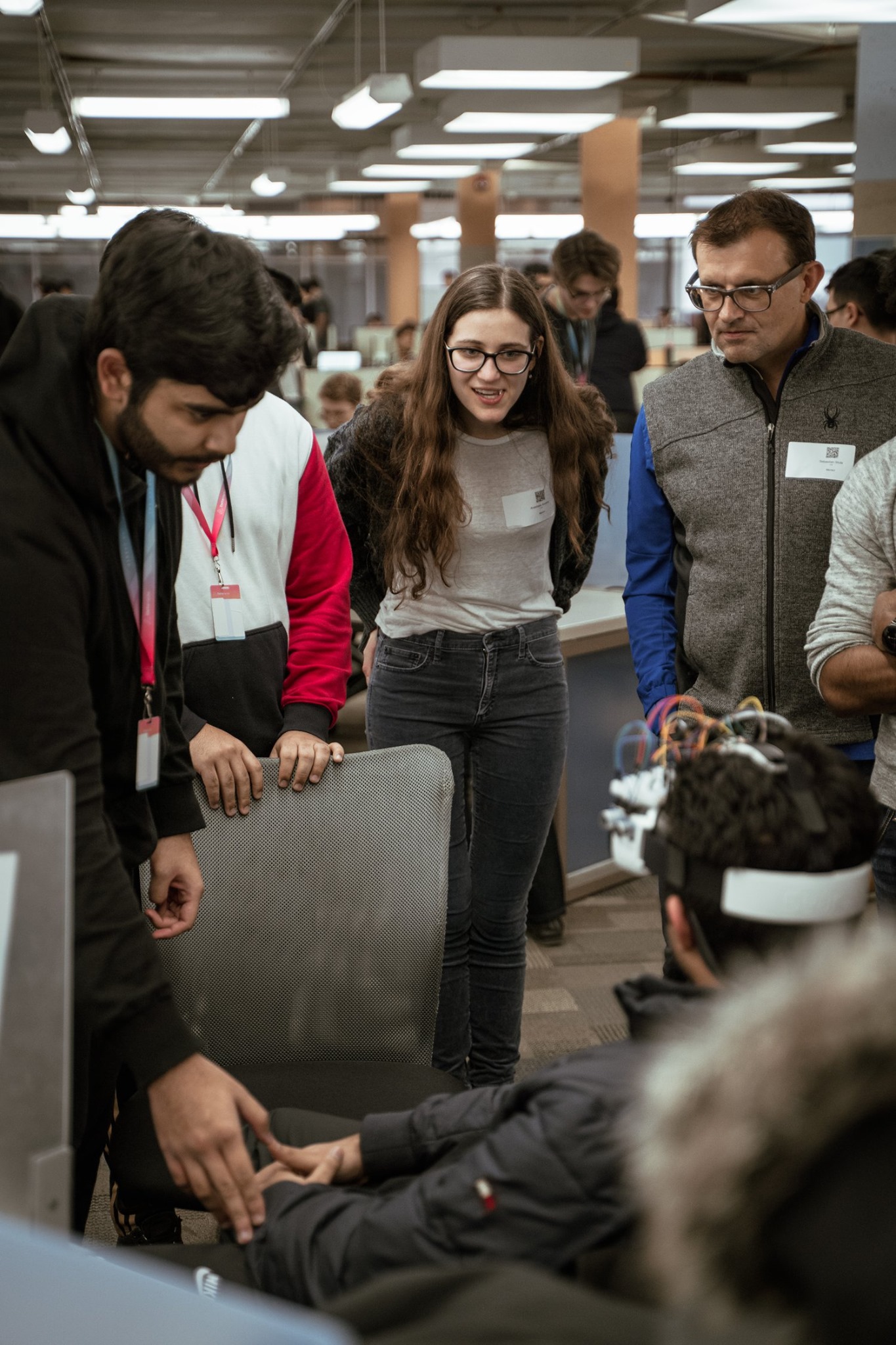 Judges at DeltaHacks 6 test and react to the VisionX project at McMaster University